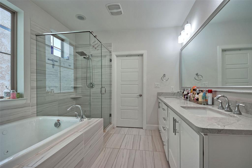 1141 Tea Olive Lane Dallas, TX 75212 - Photo 11 of 18 a bathroom with a tub a sink a mirror a shower and vanity