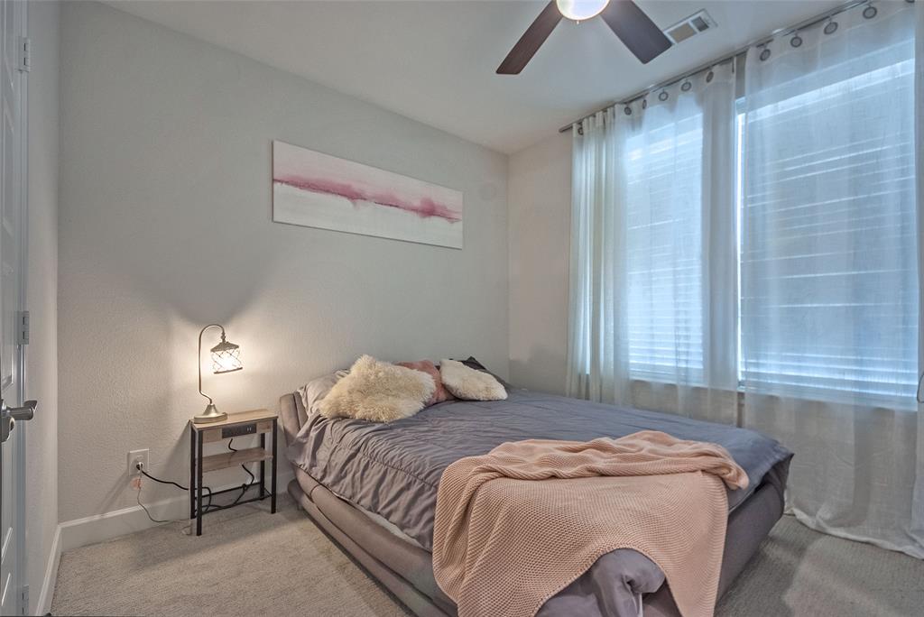 1141 Tea Olive Lane Dallas, TX 75212 - Photo 14 of 18 a bedroom with a bed and a chandelier