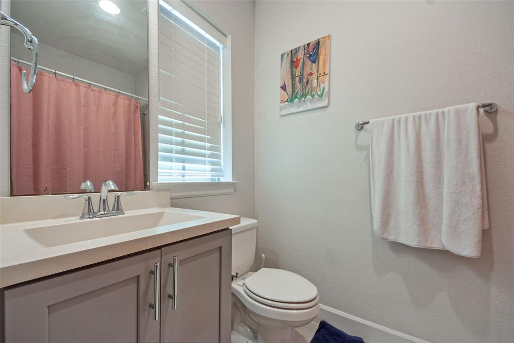 1141 Tea Olive Lane Dallas, TX 75212 - Photo 15 of 18 a bathroom with a sink a toilet and a mirror