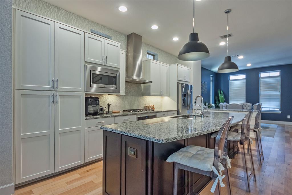 1141 Tea Olive Lane Dallas, TX 75212 - Photo 3 of 18 a kitchen with stainless steel appliances granite countertop a kitchen island a stove a cabinets a sink and a refrigerator