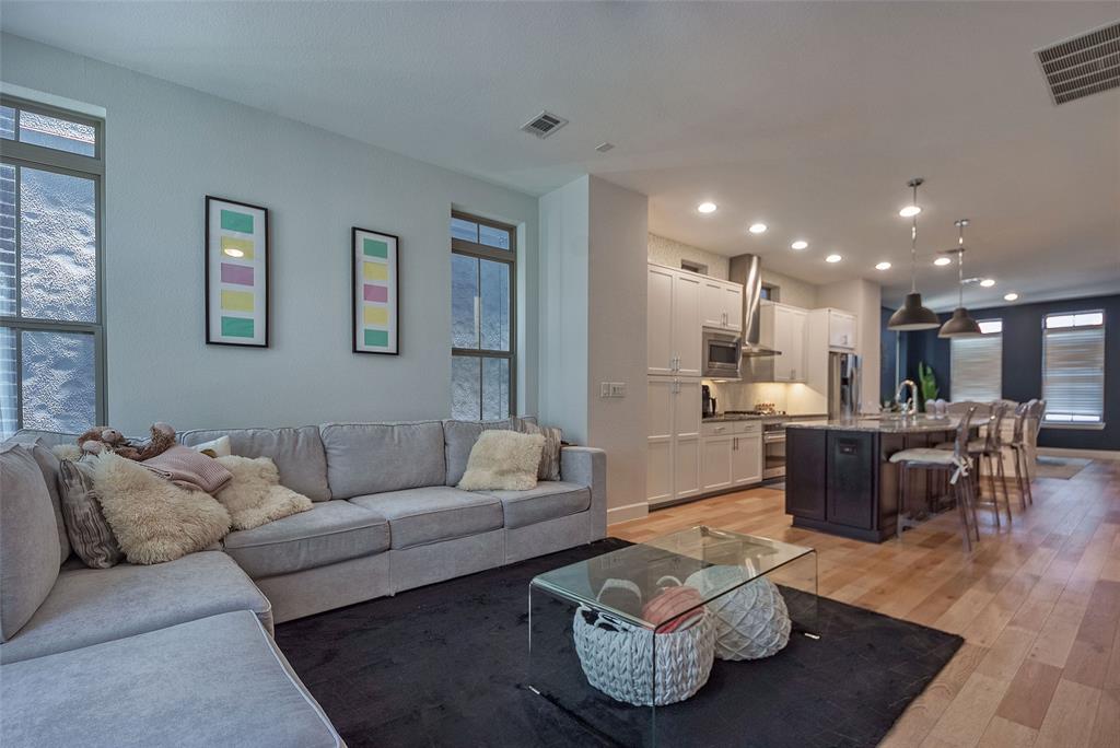 1141 Tea Olive Lane Dallas, TX 75212 - Photo 7 of 18 a living room with furniture and a dining table with wooden floor