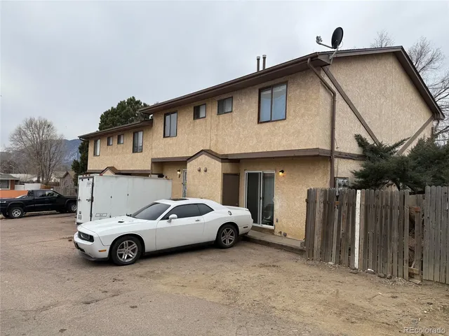 a view of a car parked in front of a house