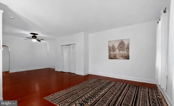 a view of a room with wooden floor and carpet