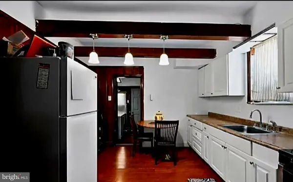 a kitchen with a refrigerator and a sink