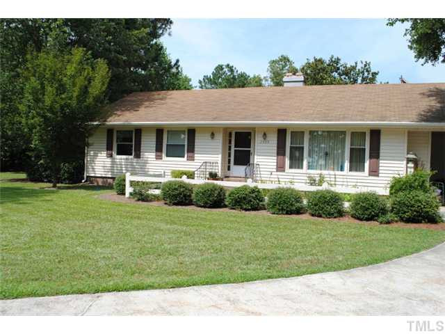 The home has a paved driveway and carport. There's a paved walkway to the front entrance. Exterior Front