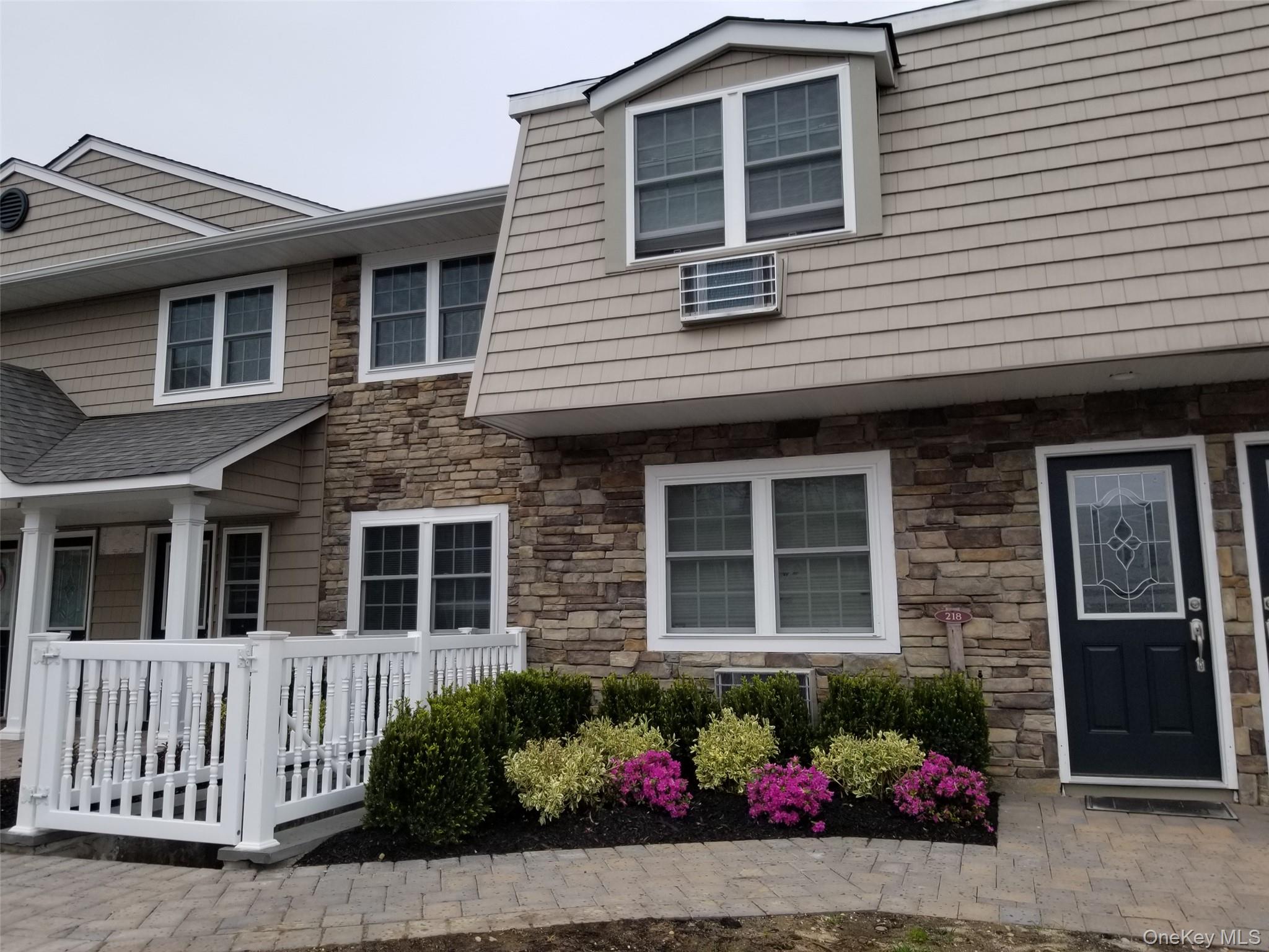 420 Terrace Road, Unit T10420 Bayport, NY 11705 - Photo 1 of 9 a front view of a house with a garden