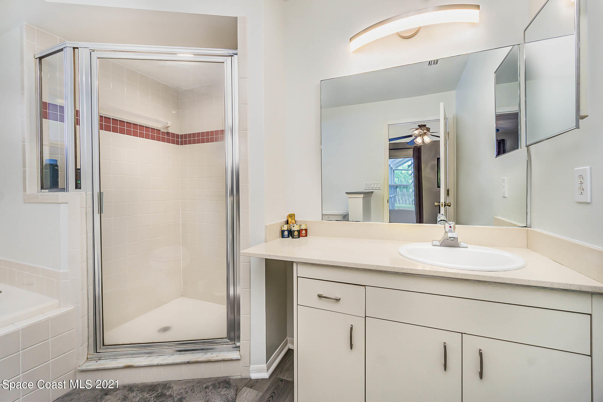 225 Crystal Lake Road Melbourne, FL 32901 - Photo 14 of 20 a bathroom with a sink and a mirror