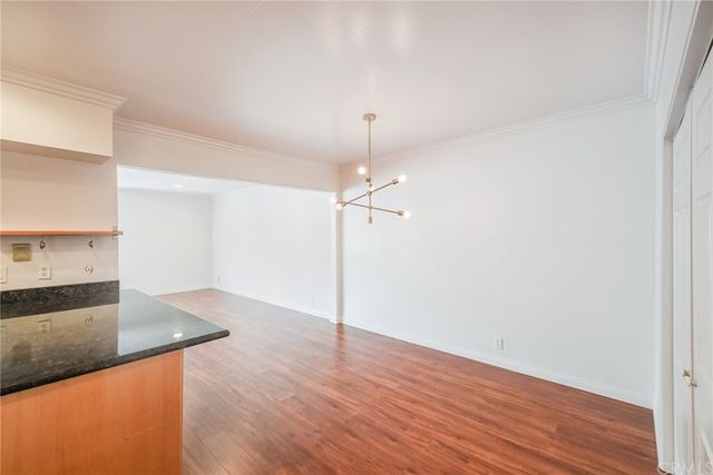 a view of a kitchen with wooden floor and a sink