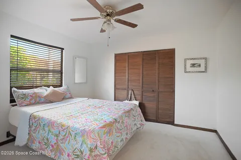 a bedroom with a bed and a closet