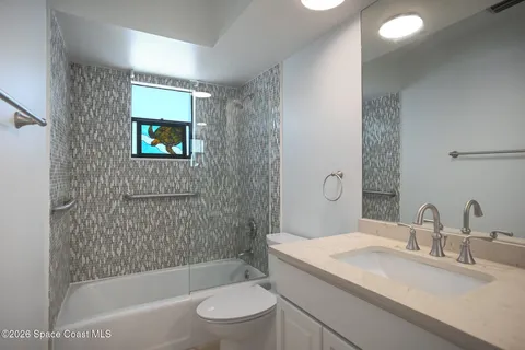 a bathroom with a sink a toilet and bathtub