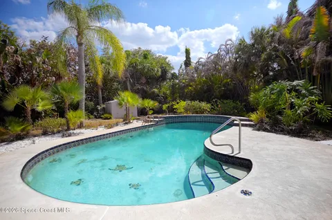 a view of a swimming pool with a yard