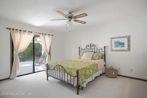 a bedroom with a bed and a ceiling fan