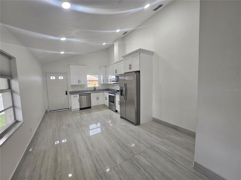 5802 Mohr Loop, Unit 5802 5804 5806 5808 Tampa, FL 33615 - Photo 11 of 40 a view of kitchen with wooden floor and electronic appliances