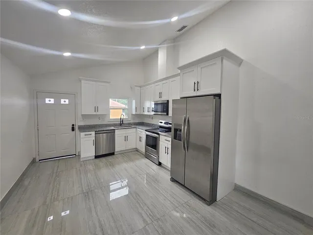 a kitchen with stainless steel appliances a refrigerator and a sink