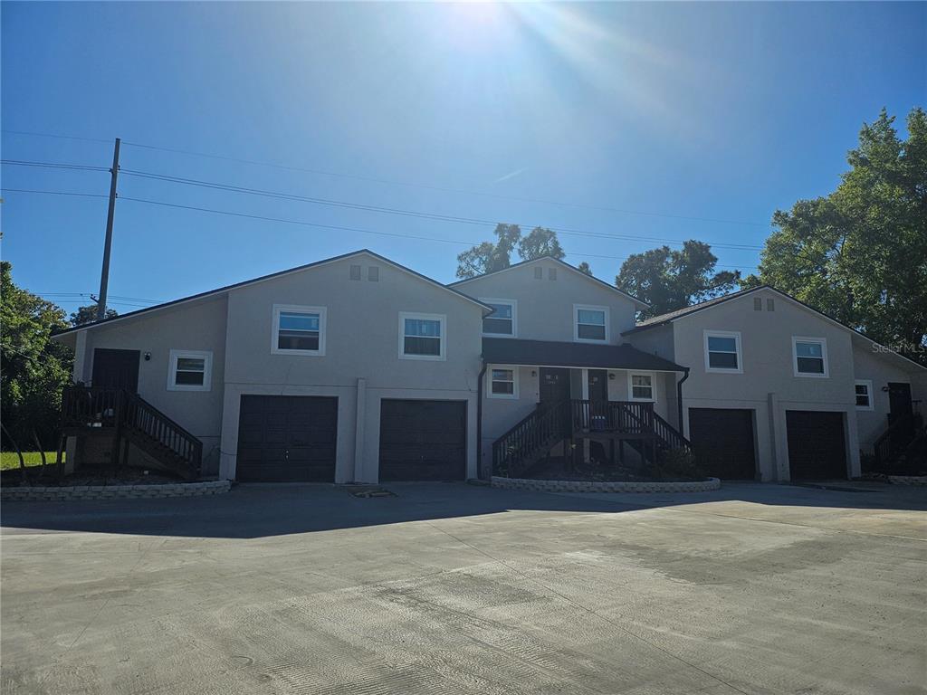 5802 Mohr Loop, Unit 5802 5804 5806 5808 Tampa, FL 33615 - Photo 6 of 40 a front view of a house with a yard and garage