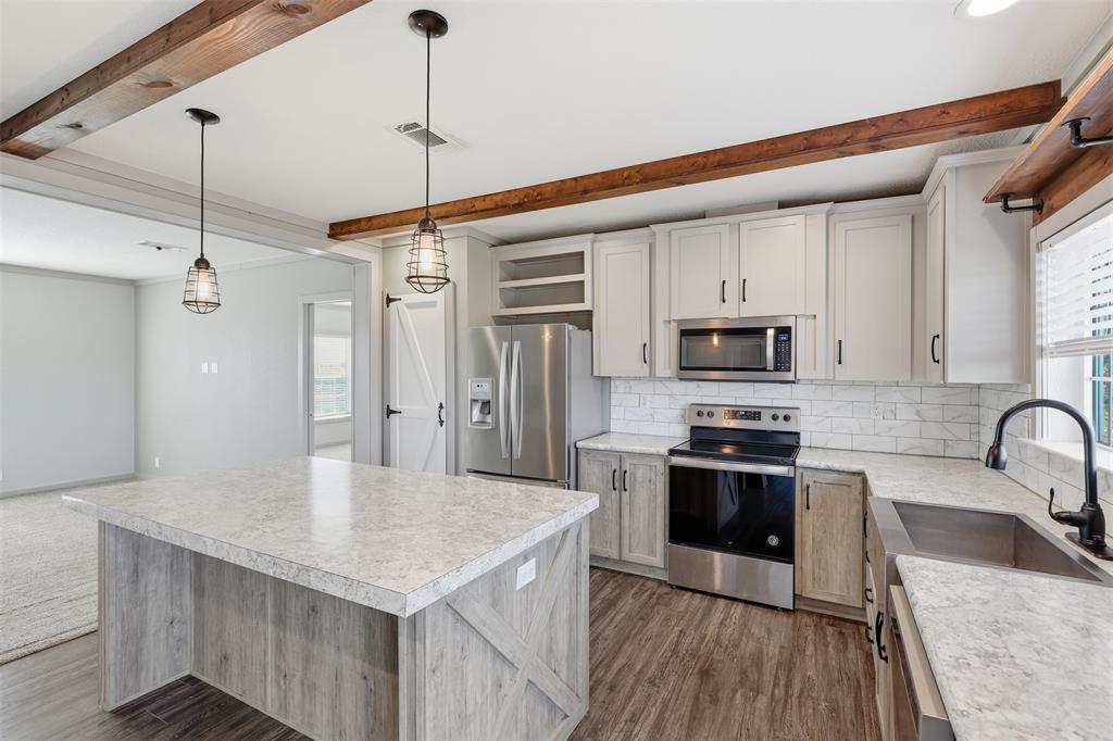 151 Private Road 3814 Springtown, TX 76082 - Photo 6 of 29 a kitchen with stainless steel appliances granite countertop a sink stove and refrigerator