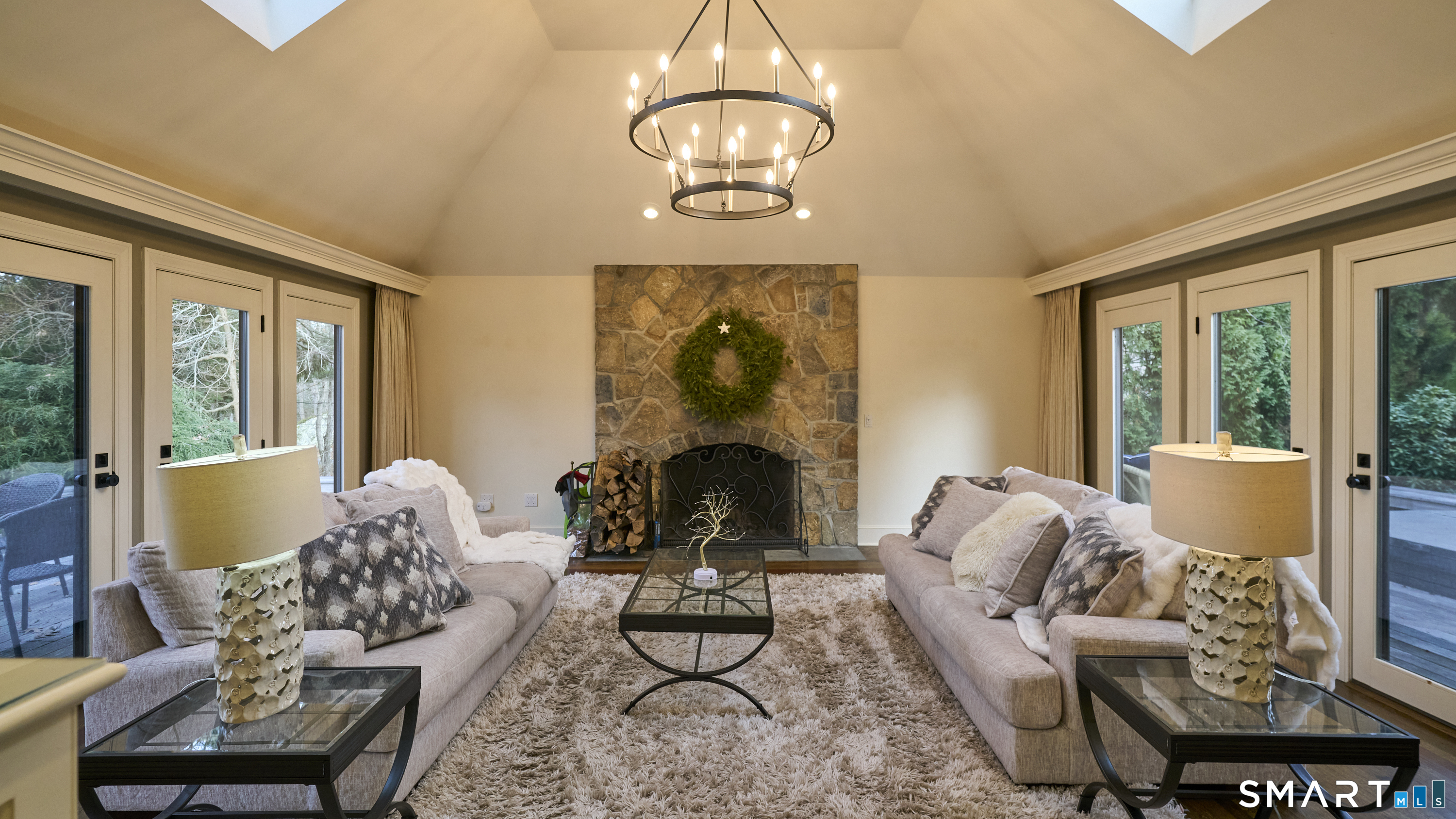 19 Money Point Road Stonington, CT 06355 - Photo 12 of 34 a living room with furniture chandelier and a fireplace
