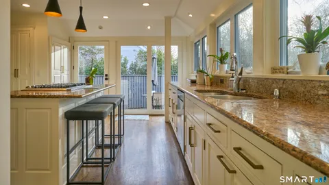 a kitchen with stainless steel appliances granite countertop counter space a sink and a large window