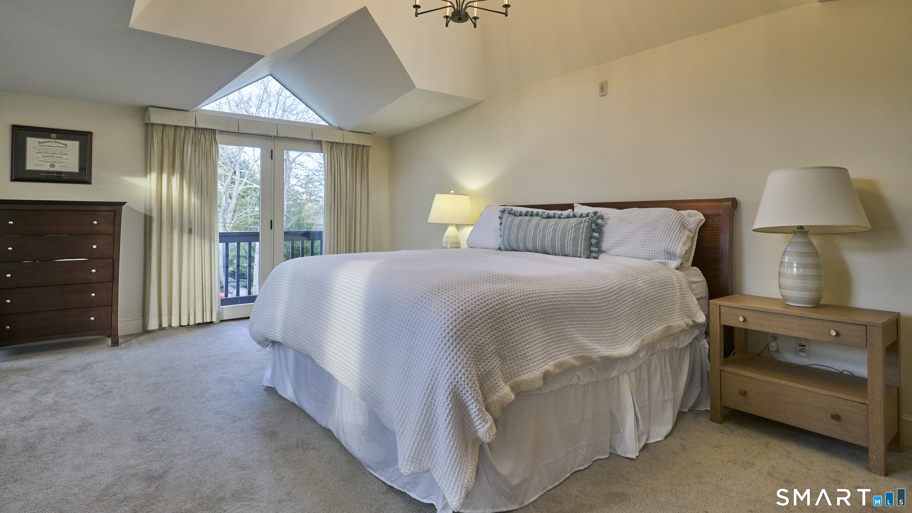 19 Money Point Road Stonington, CT 06355 - Photo 22 of 34 a spacious bedroom with a bed and a lamp