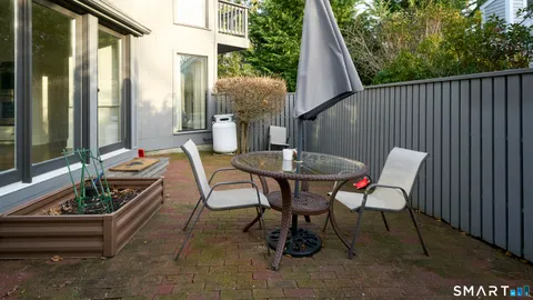 a view of a house with backyard and sitting area
