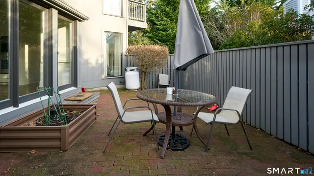 a view of a house with backyard and sitting area
