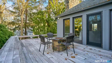 a view of a patio with table and chairs and wooden floor