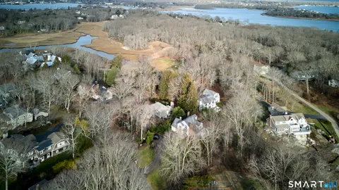 an aerial view of a house with a yard and outdoor seating