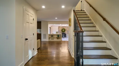 a view of a hallway view with wooden floor and staircase