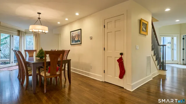 a view of a dining room with furniture wooden floor and chandelier
