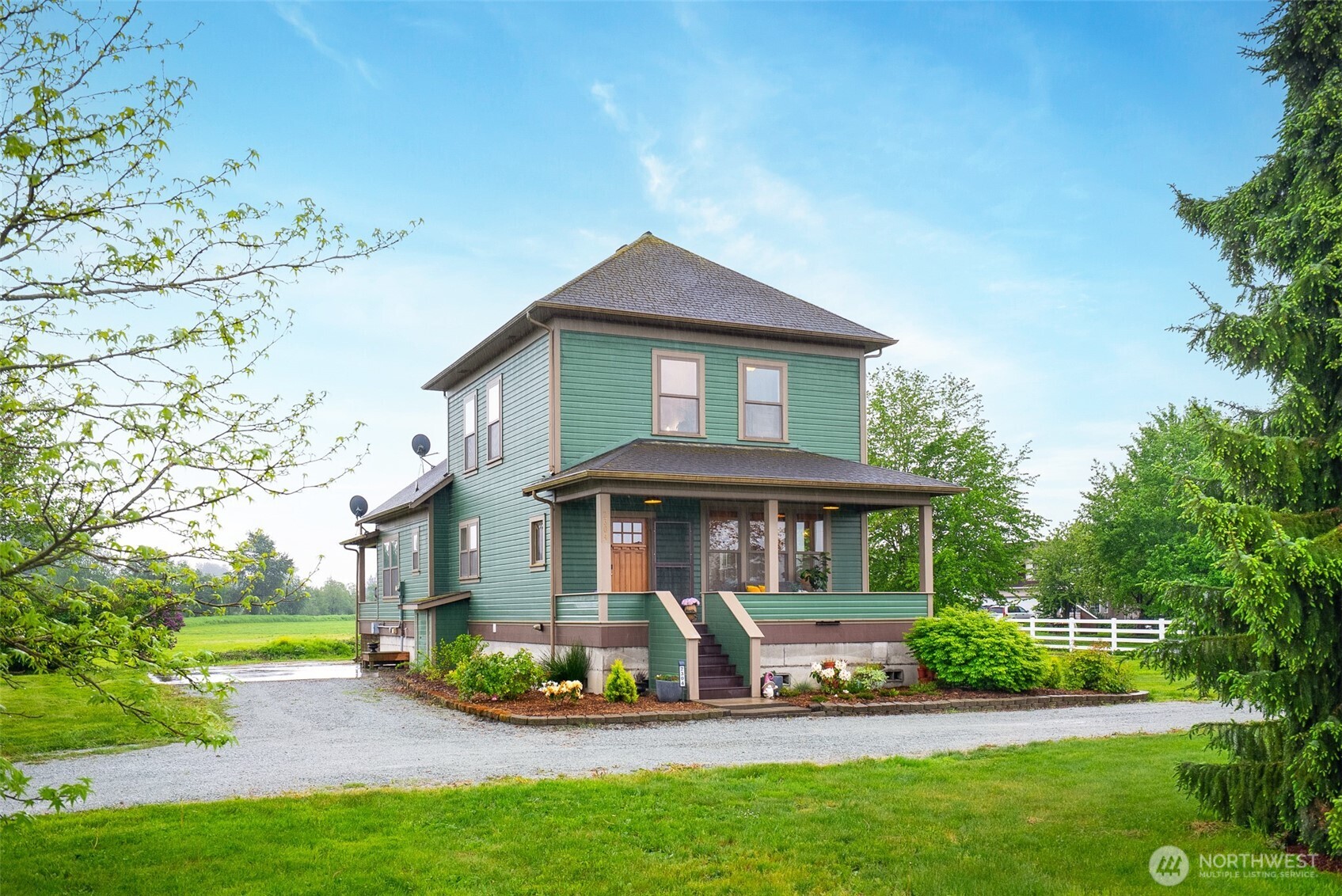 2304 Norman Road Stanwood, WA 98292 - Photo 31 of 39 a front view of a house with a yard table and chairs