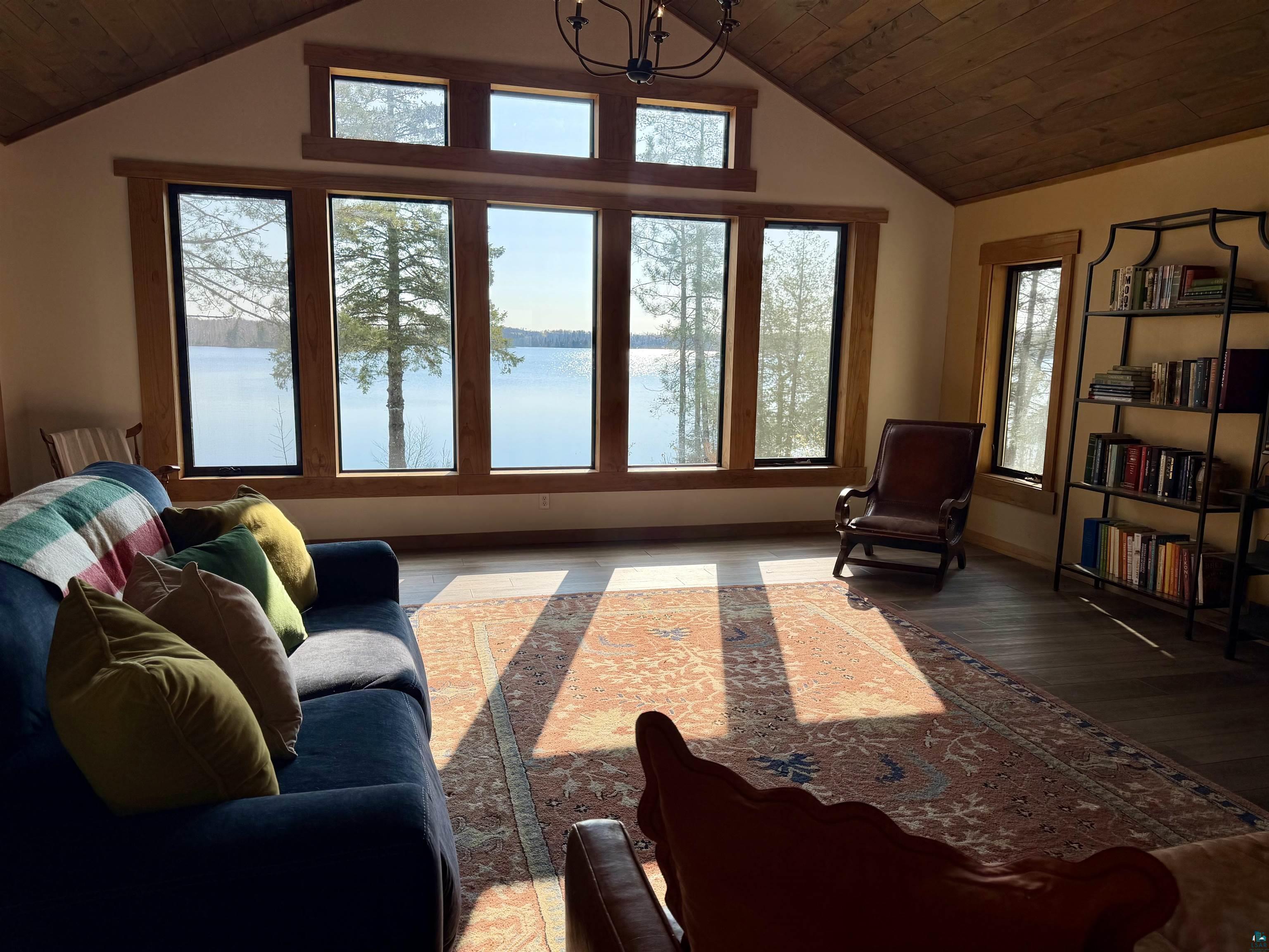 5274 Marble Lake Road Two Harbors, MN 55616 - Photo 8 of 79 Expansive window wall with natural wood trim framing water and tree scenery