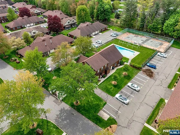 an aerial view of a house with garden space and street view