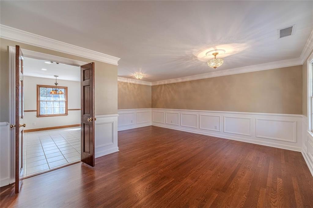 565 James Street Southwest Lilburn, GA 30047 - Photo 12 of 67 wooden floor in an empty room with a window