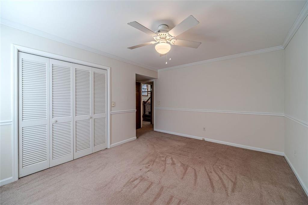 565 James Street Southwest Lilburn, GA 30047 - Photo 20 of 67 an empty room with closet and fan