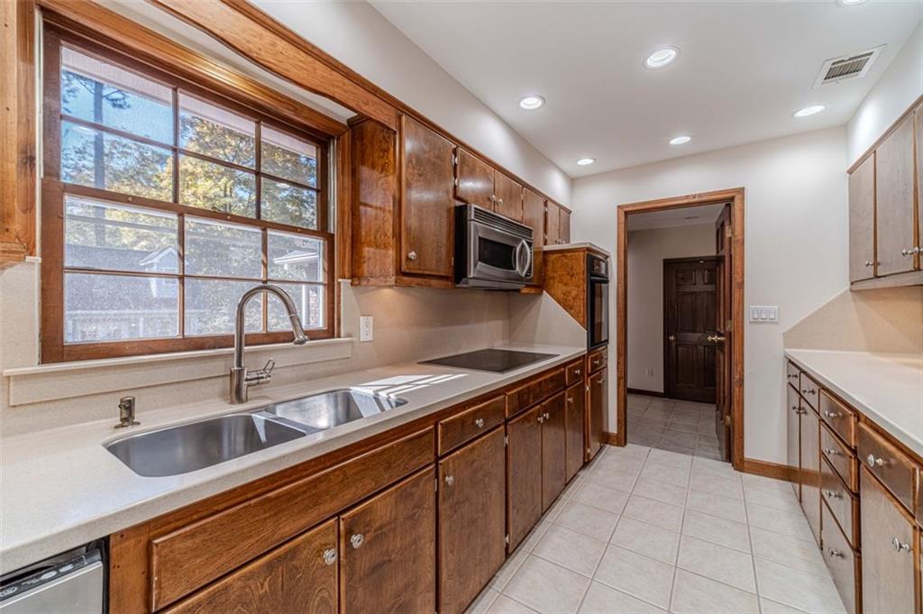 565 James Street Southwest Lilburn, GA 30047 - Photo 24 of 67 a kitchen with stainless steel appliances granite countertop a sink and a stove