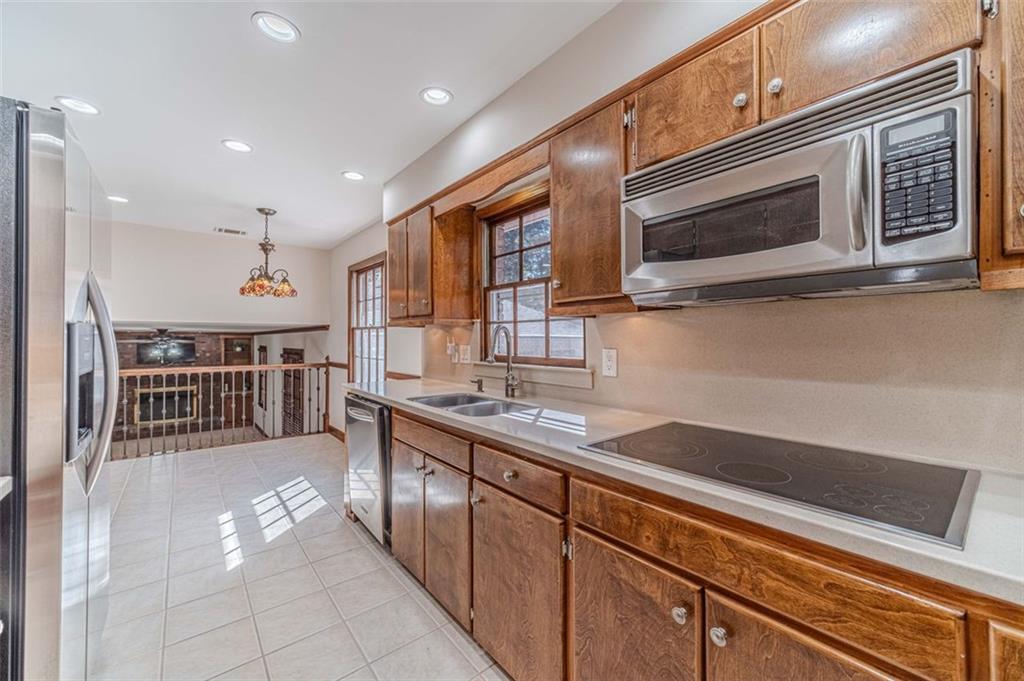 565 James Street Southwest Lilburn, GA 30047 - Photo 25 of 67 a kitchen with stainless steel appliances sink microwave and stove