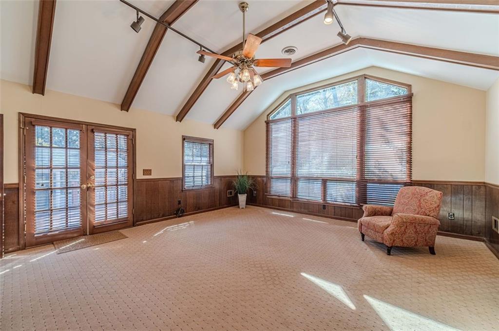 565 James Street Southwest Lilburn, GA 30047 - Photo 31 of 67 a living room with furniture and a floor to ceiling window