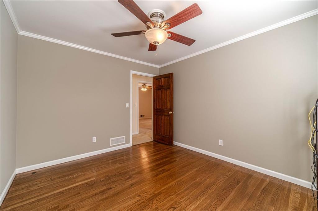 565 James Street Southwest Lilburn, GA 30047 - Photo 34 of 67 a view of an empty room with window and wooden floor