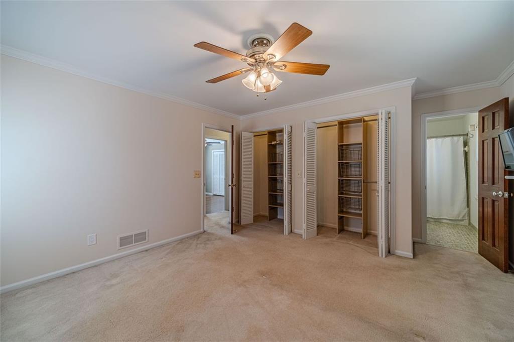 565 James Street Southwest Lilburn, GA 30047 - Photo 37 of 67 an empty room with closet and a ceiling fan