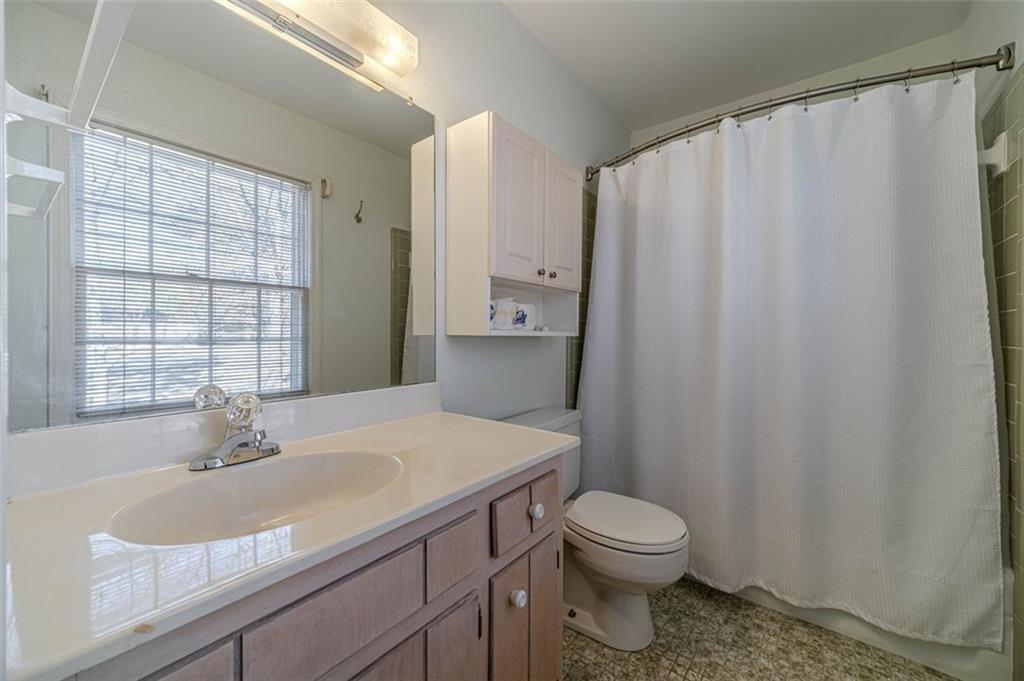 565 James Street Southwest Lilburn, GA 30047 - Photo 38 of 67 a bathroom with a sink a toilet and shower curtain