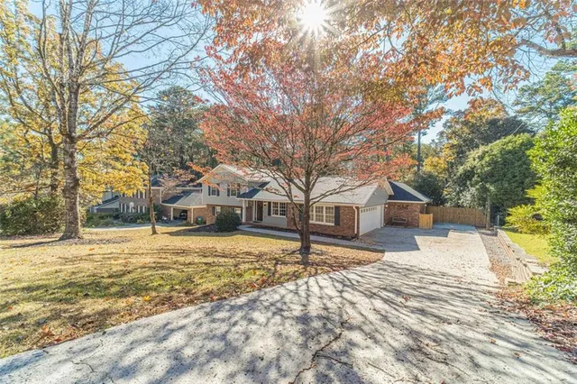 a front view of a house with a yard covered in snow