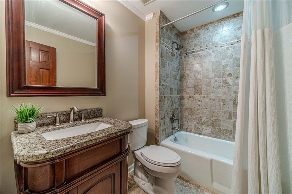 565 James Street Southwest Lilburn, GA 30047 - Photo 41 of 67 a bathroom with a granite countertop sink toilet and shower