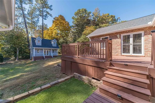 a view of a house with a yard and wooden fence