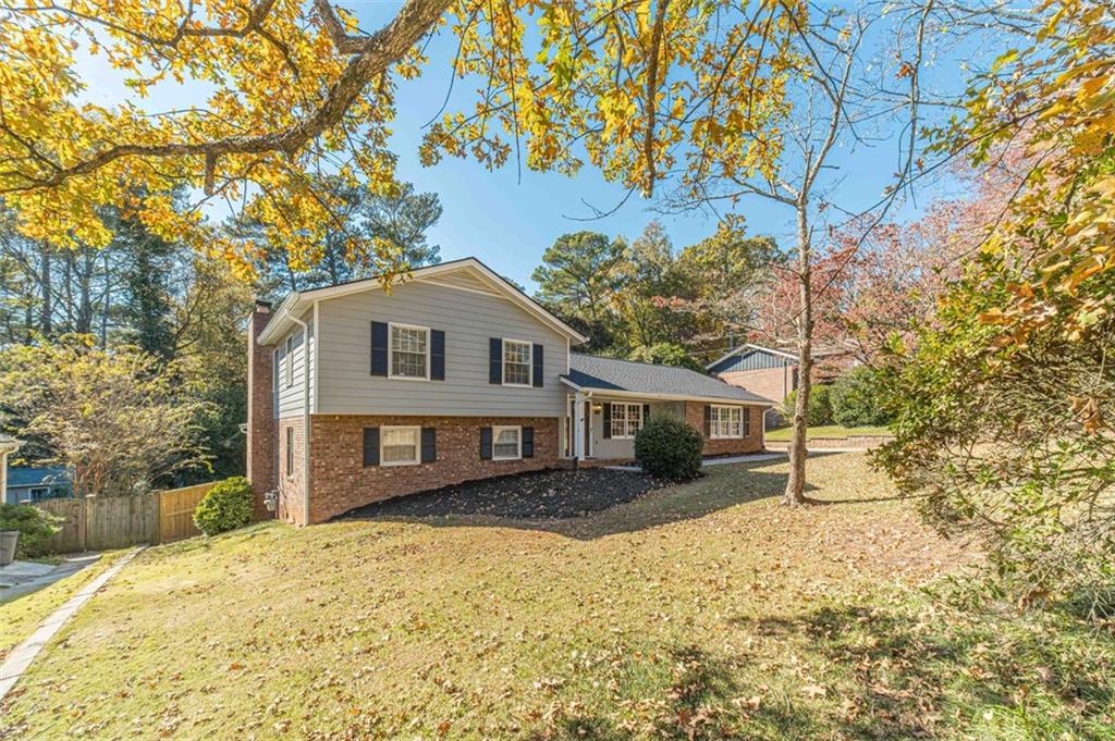 565 James Street Southwest Lilburn, GA 30047 - Photo 5 of 67 a front view of a house with a yard covered with snow and trees
