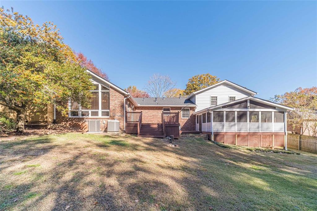 565 James Street Southwest Lilburn, GA 30047 - Photo 57 of 67 a view of a house with a big yard and large trees