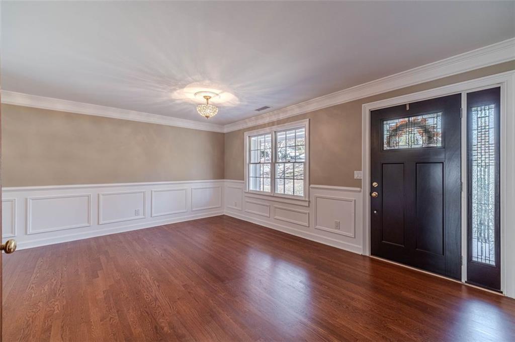 565 James Street Southwest Lilburn, GA 30047 - Photo 10 of 67 a view of an empty room with wooden floor and a window
