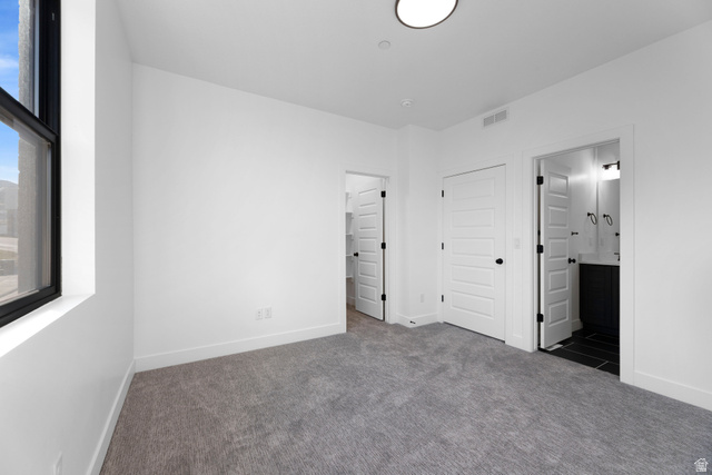 14392 South Champ Cove Draper, UT 84020 - Photo 20 of 31 Unfurnished bedroom with dark colored carpet, a closet, and ensuite bath