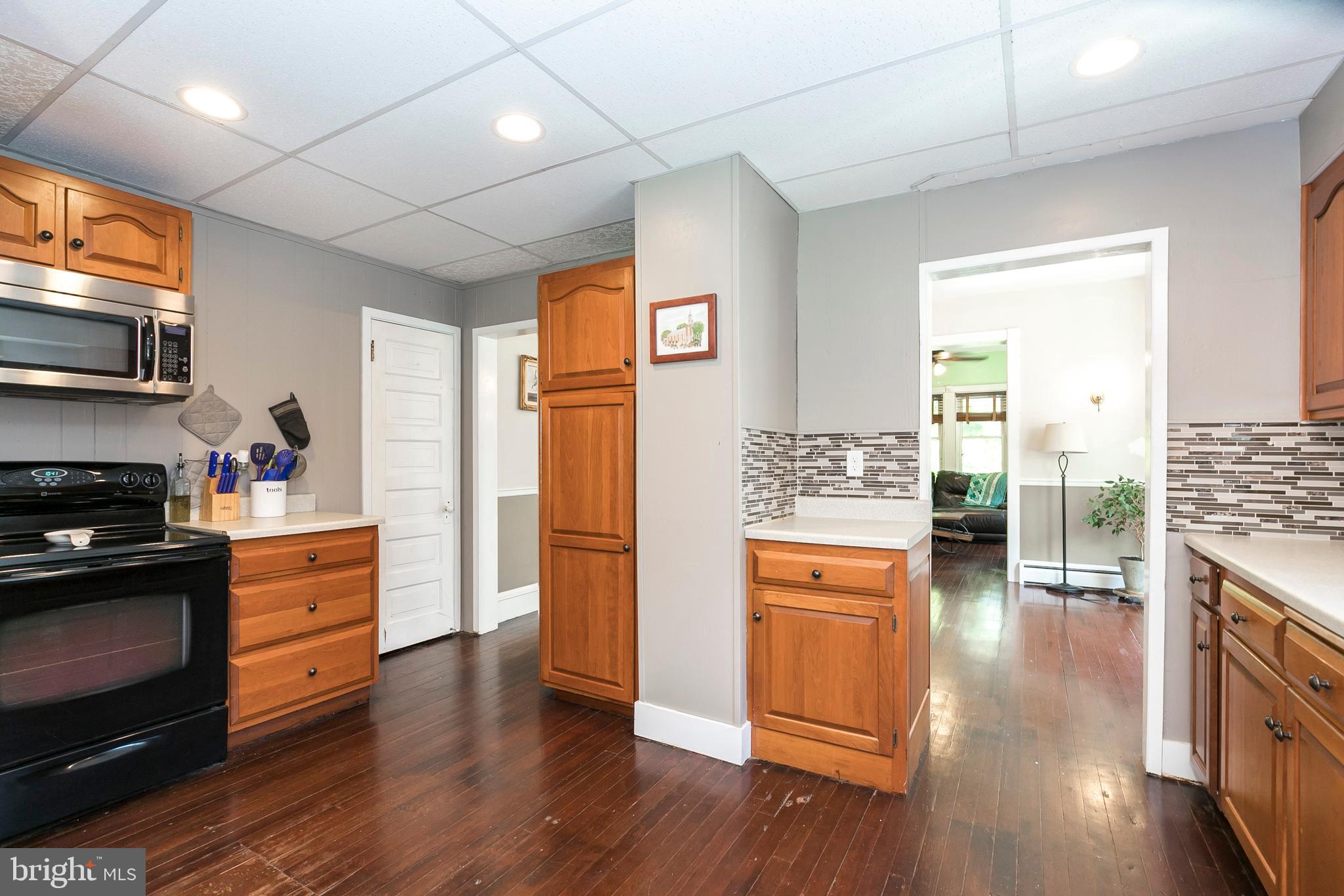 2190 School Road Pottstown, PA 19465 - Photo 11 of 30 a kitchen with stainless steel appliances wooden floor and a refrigerator