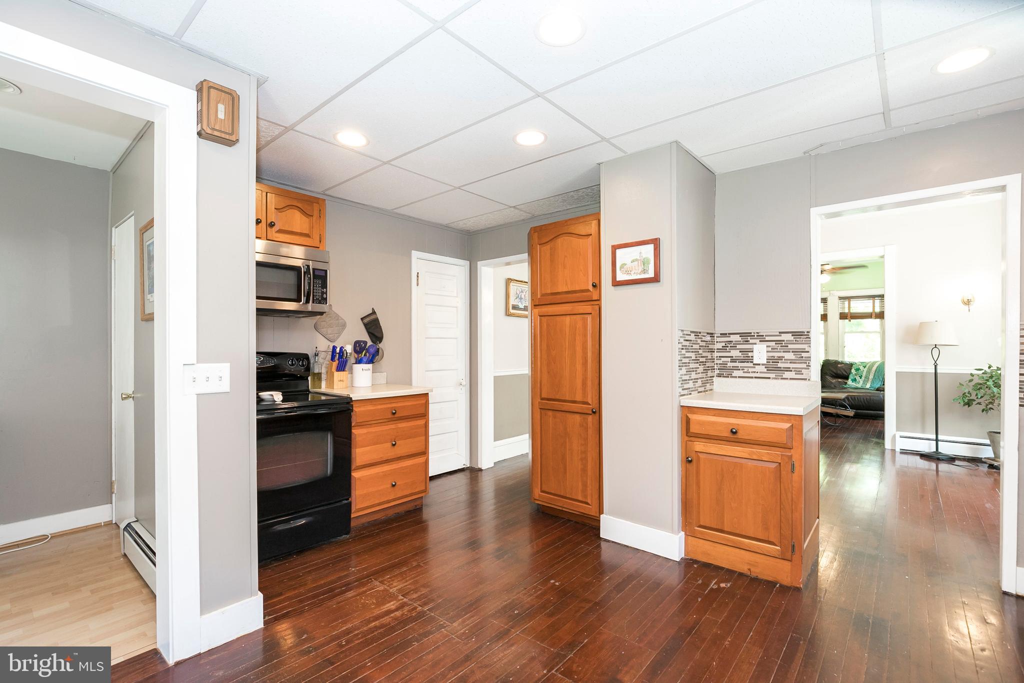 2190 School Road Pottstown, PA 19465 - Photo 12 of 30 a kitchen with stainless steel appliances granite countertop a refrigerator a stove top oven and a wooden floors