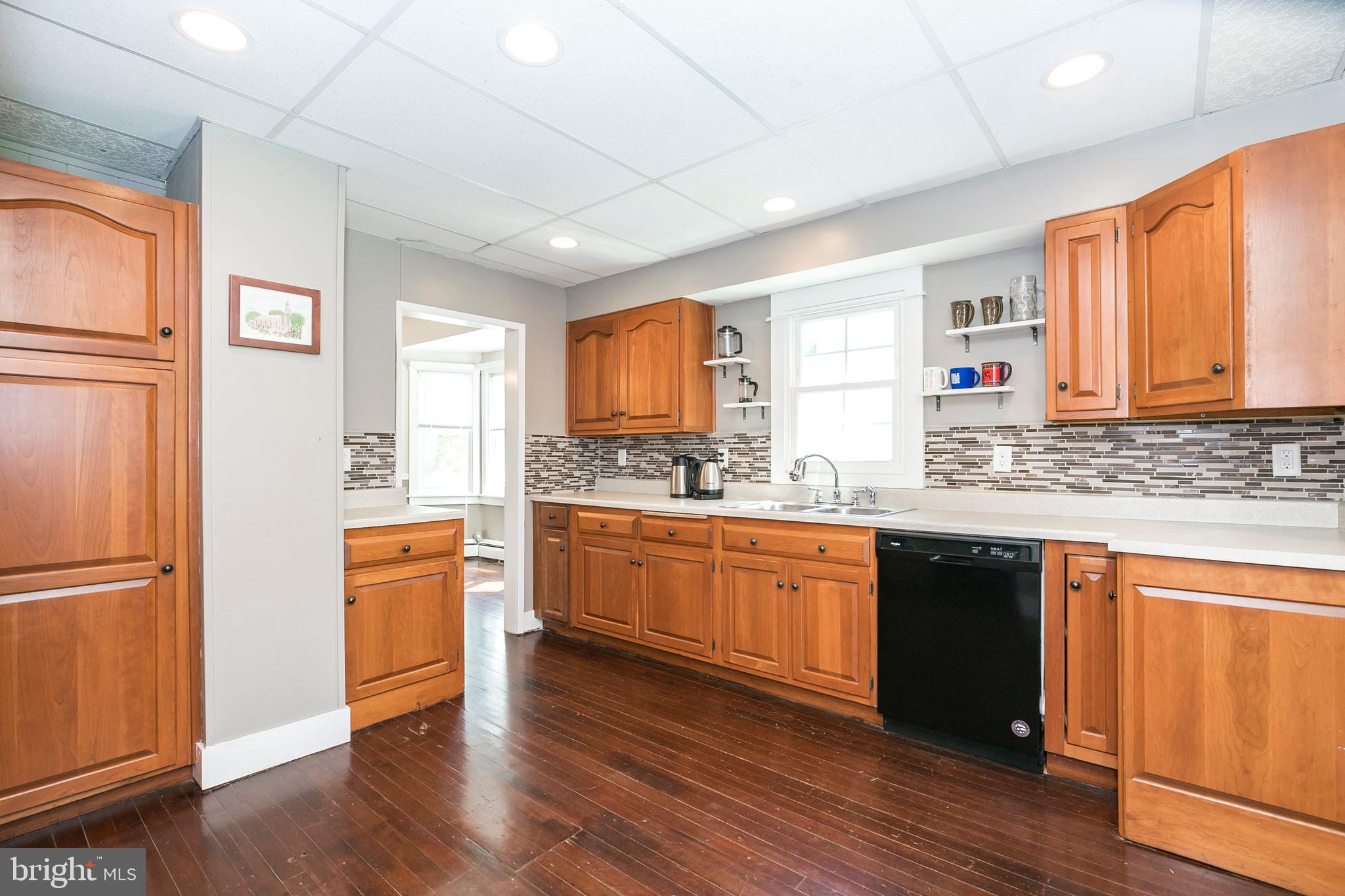 2190 School Road Pottstown, PA 19465 - Photo 14 of 30 a large kitchen with stainless steel appliances granite countertop a refrigerator a sink dishwasher a stove with wooden cabinets and wooden floor